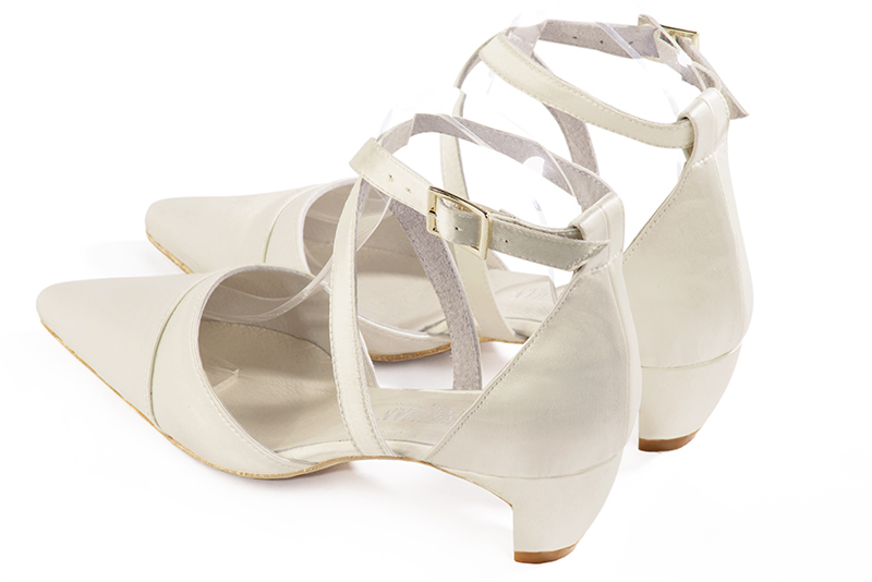 Off white women's open side shoes, with crossed straps. Pointed toe. Low comma heels. Rear view - Florence KOOIJMAN